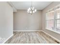 Open dining area featuring wood floors and a modern chandelier, perfect for entertaining at 12679 Chargers Ct, Fishers, IN 46037