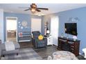 Relaxing living room with fireplace, ceiling fan, comfortable seating, and stylish decor elements at 12901 N Collett Way, Camby, IN 46113