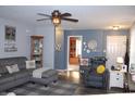 Inviting living room with gray sectional, ceiling fan, and a view into another room, great for relaxing at 12901 N Collett Way, Camby, IN 46113