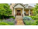 Charming front entrance features beautiful landscaping and a classic wood door at 13346 W Sherbern Dr, Carmel, IN 46032