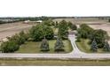 Picturesque aerial view showcasing a home with expansive, well-manicured lawn surrounded by verdant trees and open fields at 13666 E 166Th St, Noblesville, IN 46060