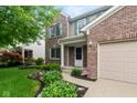 Charming two-story home with a well-manicured lawn, brick accents and attached two-car garage at 14446 Chapelwood Ln, Fishers, IN 46037