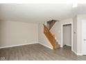 Bright, airy living room featuring neutral paint, hard surface floors, and a stairway to the second floor at 14446 Chapelwood Ln, Fishers, IN 46037