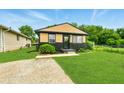 Charming single Gathering home with manicured lawn, neutral paint scheme and welcome wreath on the front door at 1513 S Rural St, Indianapolis, IN 46203