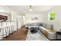 Spacious living room boasts modern decor, new flooring, and an open concept design with lots of natural light at 1513 S Rural St, Indianapolis, IN 46203