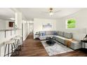 Bright living room features new flooring and neutral paint, with modern furniture adding to the updated style at 1513 S Rural St, Indianapolis, IN 46203
