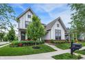 Elegant two-story home with pristine lawn, a variety of trees, and charming curb appeal at 1586 Mairn Ave, Carmel, IN 46032