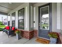 Inviting front porch with stylish seating and decorative plants, perfect for relaxing outdoors at 1586 Mairn Ave, Carmel, IN 46032
