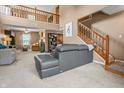 Spacious living room with a two-story foyer, staircase, and comfortable seating at 1605 Perry Commons Blvd, Indianapolis, IN 46217