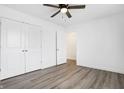 A bedroom with a ceiling fan, closet, and stylish gray wood flooring at 1612 Paula Dr, Columbus, IN 47201