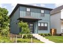 Beautiful home featuring eye-catching blue siding, well-kept lawn, and concrete walkway at 1717 Carrollton Ave, Indianapolis, IN 46202