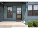 Inviting front porch with stylish front door, modern lighting fixtures, and manicured shrubbery at 1717 Carrollton Ave, Indianapolis, IN 46202