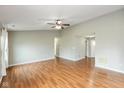 Bright living room features hardwood floors, ceiling fan and access to other living areas at 18005 Gasparilla Ct, Westfield, IN 46062