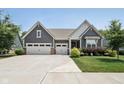 Home featuring a three-car garage, manicured lawn, and appealing curb appeal at 18998 Beverly Shones Ln, Noblesville, IN 46062