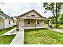 Charming single-story home featuring a welcoming front porch and well-maintained lawn, creating a cozy curb appeal at 2026 Spruce St, Indianapolis, IN 46203