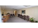 A waiting area with chairs, plants, and carpeted floors at 22 W 8Th St, Anderson, IN 46016