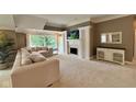 Cozy living room with a fireplace, built-in cabinets, and outdoor views at 2213 E Canterbury Ct, Martinsville, IN 46151