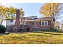 Exterior of home with deck, brick chimney, and spacious backyard at 2457 N Centerline Rd, Franklin, IN 46131