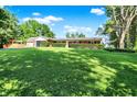 Well maintained home featuring a spacious yard with mature trees on a sunny day at 2907 Jay Dee Ln, Greenwood, IN 46143