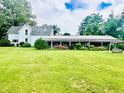 Expansive green backyard featuring a long porch area and a swing offering a peaceful outdoor retreat at 317 W State Road 44, Franklin, IN 46131