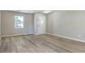 Bright entryway features wood-look flooring, fresh paint, and a window view of the front yard at 3351 Summer Breeze Cir, Indianapolis, IN 46239
