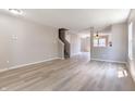 Open living room boasts modern wood-look floors, neutral paint, and seamless flow to other spaces at 3351 Summer Breeze Cir, Indianapolis, IN 46239