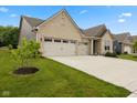 Well-maintained home with a three-car garage, a lush lawn, and tasteful landscaping at 3599 Chalmers Dr, Bargersville, IN 46106