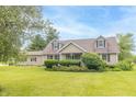 Charming home with a lush green lawn, mature trees, and meticulously manicured shrubs adding to its curb appeal at 391 W 500 S, Anderson, IN 46013