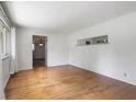 Bright living room features hardwood floors, and neutral paint, with an open view into the next room at 406 W Mcgregor Rd, Indianapolis, IN 46217