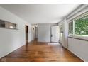 Sunlit living room with hardwood floors, and a neutral color scheme, showcasing the front door at 406 W Mcgregor Rd, Indianapolis, IN 46217