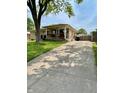 Charming single-story home with a long driveway and well-maintained landscaping at 419 N 14Th Ave, Beech Grove, IN 46107