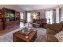 Inviting living room with a beautiful hardwood floor, entertainment center, and bright natural light at 421 Kingsway Ct, Mooresville, IN 46158