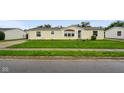 Inviting single-story house with a neat front lawn and tidy landscaping at 4697 W Ridge Dr, Columbus, IN 47203