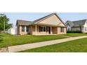 Traditional brick home featuring a well-kept lawn and a cozy front porch area at 524 S Meridian S St, Lebanon, IN 46052
