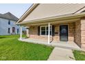 Inviting covered porch with brick accents, offering a welcoming entryway to the home at 524 S Meridian S St, Lebanon, IN 46052