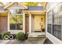 Close-up of the front entryway highlighting the large windows and brick accents at 5303 Windridge Dr # 172, Indianapolis, IN 46226