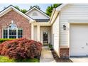 Inviting front entrance with a well manicured landscape and a decorative storm door at 5883 Hollow Oak, Carmel, IN 46033