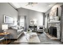Stylish living room with a fireplace, plush sofa, and elegant decor, perfect for relaxation at 5883 Hollow Oak, Carmel, IN 46033