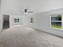 Spacious room with carpet, many windows allowing natural light in, and a simple ceiling fan at 8437 Crosser Dr, Indianapolis, IN 46237