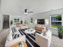 Bright living room showcasing stylish furnishings, a modern ceiling fan, and lots of natural light at 8437 Crosser Dr, Indianapolis, IN 46237
