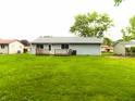 Large, grassy backyard featuring a small wood deck perfect for entertaining at 8609 Stonewall Dr, Indianapolis, IN 46231