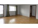 Bright living room with laminate flooring and a large window, perfect for natural light at 8609 Stonewall Dr, Indianapolis, IN 46231