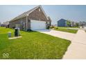 Brick home with attached garage and well maintained front yard at 9001 Fitzgerald Dr, Indianapolis, IN 46239