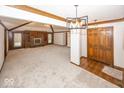 Open-concept living room showcasing fireplace, built-in shelving, natural light, and elegant wood and carpet flooring at 9133 Log Run N Dr, Indianapolis, IN 46234