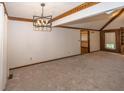 Spacious living room with vaulted ceilings, wood trim detail, and neutral carpet creating a warm, inviting space at 9133 Log Run N Dr, Indianapolis, IN 46234