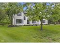 Beautiful white brick home featuring black shutters and a well-maintained lawn at 9148 Oak Knoll Ln, Fishers, IN 46037