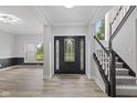 Spacious foyer boasts hardwood floors and an elegant staircase with carpeted steps at 9148 Oak Knoll Ln, Fishers, IN 46037