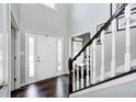 Elegant foyer features hardwood floors, high ceilings, and a staircase with white railings at 10717 Windermere Blvd, Fishers, IN 46037