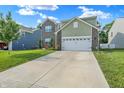 Two-story home with a brick and siding exterior and a concrete driveway at 10902 Jimmy Lake Dr, Indianapolis, IN 46239