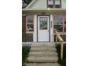 Close-up of the front entrance, showing the house number, stylish door, and steps at 1115 N Kealing Ave, Indianapolis, IN 46201